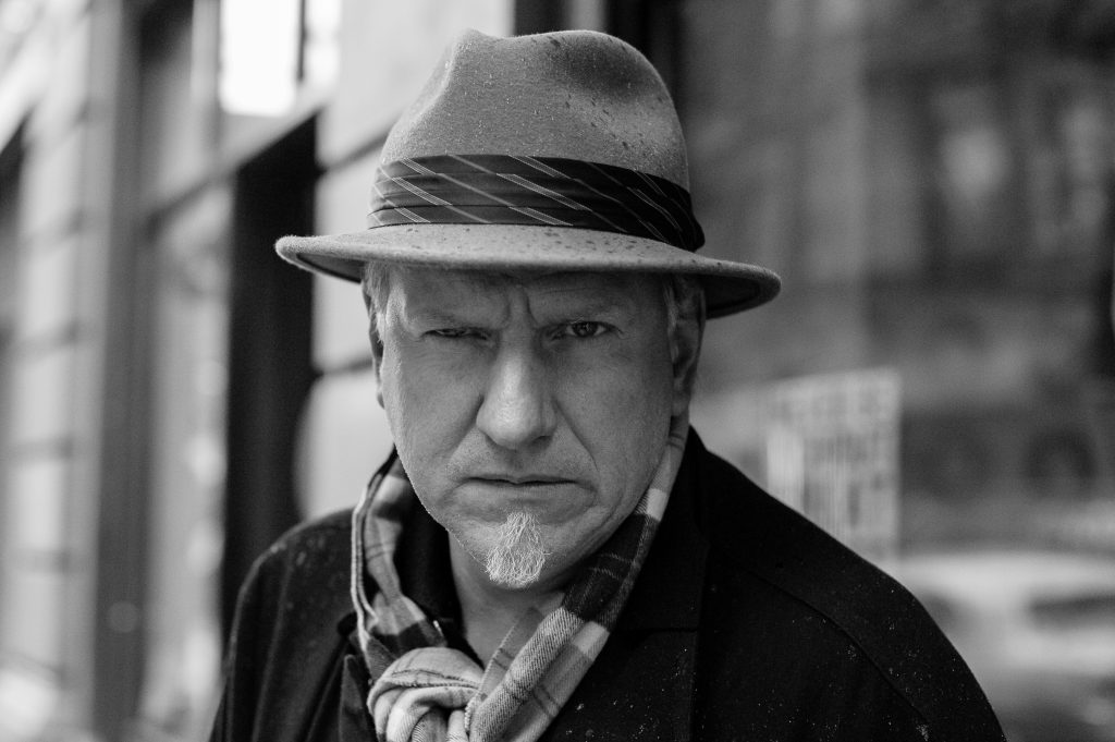 man in hat staring at camera