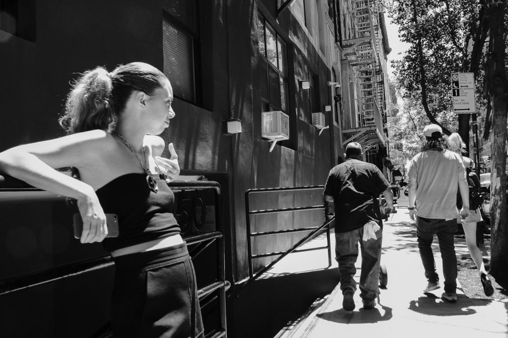 woman watching 2 men walking past her
