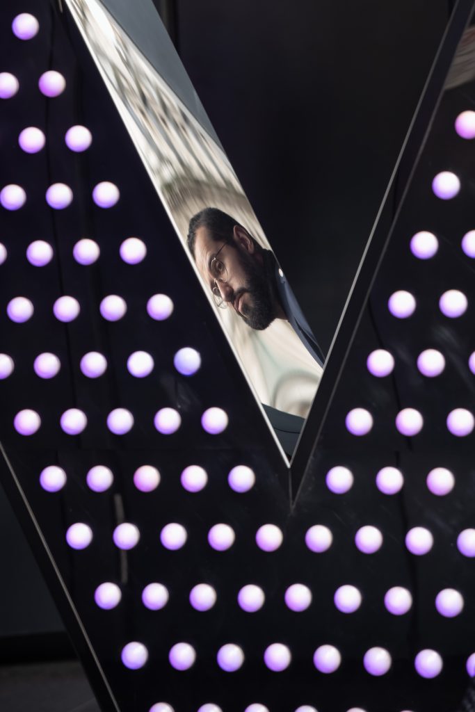 Using your vision to take photographs like this. A face reflected in a light sculpture